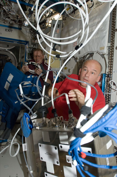 NASA Copyright 2009,  ISS021-E-006177 (14 Oct. 2009) --- NASA astronaut Jeffrey Williams, Expedition 21 flight engineer, works with the Portable Pulmonary Function System (PPFS) in the Destiny laboratory of the International Space Station. European Space Agency astronaut Frank De Winne, commander, works in the background. 