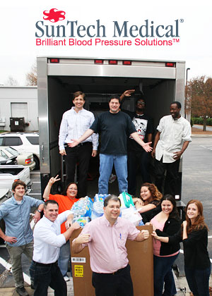 SunTech employees load food on a Food Bank truck